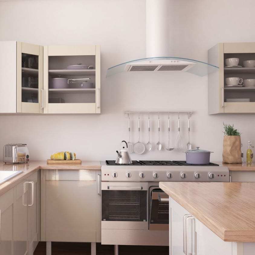 Cream kitchen with a stainless range and curved extractor hood